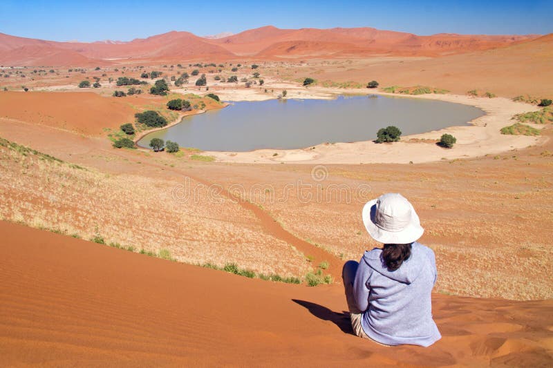 Woman traveler in Africa, vacation in Namibia, looking at beautiful Namib desert landscape. Woman traveler in Africa, vacation in Namibia, looking at beautiful Namib desert landscape
