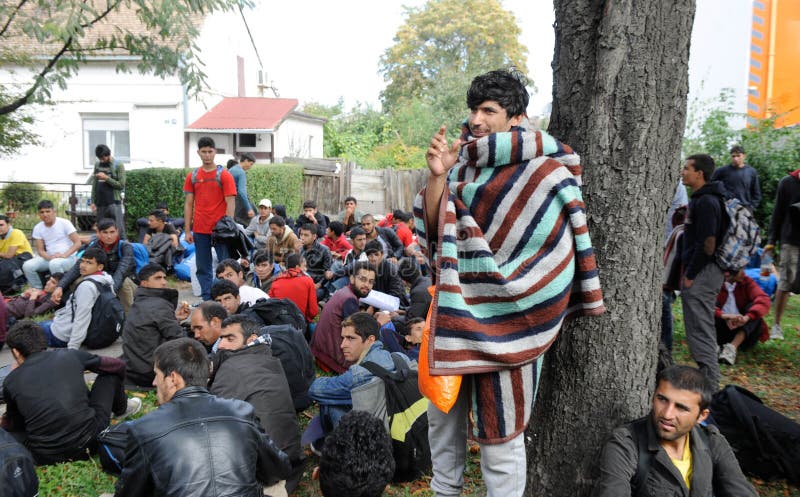 NOVA PAZOVA, SERBIA - CIRCA OCTOBER 2016: Migrants from middle east walks to Hungarian border, circa October 2016 in Nova Pazova. NOVA PAZOVA, SERBIA - CIRCA OCTOBER 2016: Migrants from middle east walks to Hungarian border, circa October 2016 in Nova Pazova