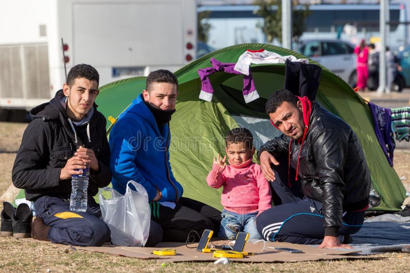 Polykastro, Greece, February 7, 2016: Thousands migrants and refugees are waiting in the parking lot of a gas station in order to cross the borders to FYR of Macedonia. Polykastro, Greece, February 7, 2016: Thousands migrants and refugees are waiting in the parking lot of a gas station in order to cross the borders to FYR of Macedonia