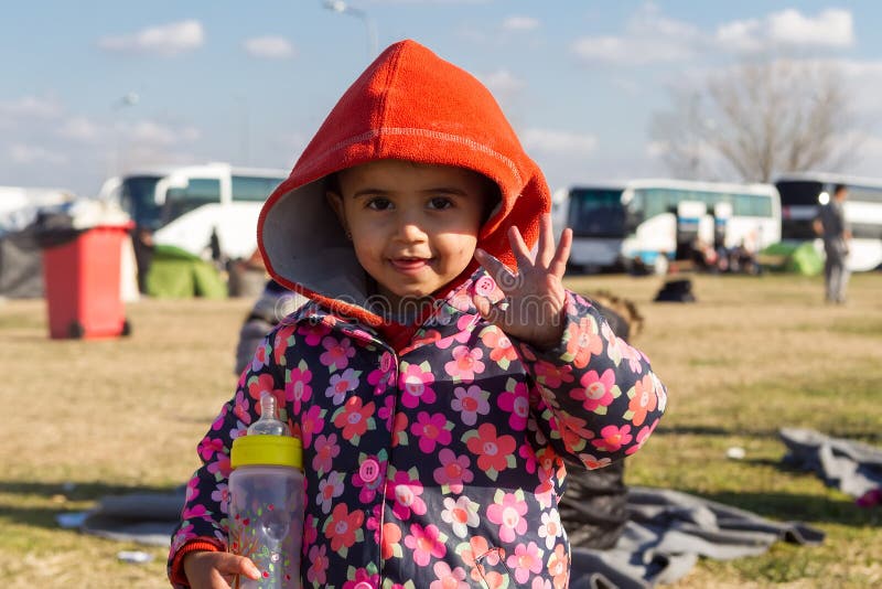 Polykastro, Greece, February 7, 2016: Thousands migrants and refugees are waiting in the parking lot of a gas station in order to cross the borders to FYR of Macedonia. Polykastro, Greece, February 7, 2016: Thousands migrants and refugees are waiting in the parking lot of a gas station in order to cross the borders to FYR of Macedonia