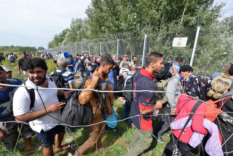 HORGOS, SERBIA - SEPTEMBER 15 : A large group of refugees from Middle East at the closed hungarian border with Serbia on September 15th, 2015. The migrants are waiting for the authorities to open the border crossing, so they can continue to the northern european countries. HORGOS, SERBIA - SEPTEMBER 15 : A large group of refugees from Middle East at the closed hungarian border with Serbia on September 15th, 2015. The migrants are waiting for the authorities to open the border crossing, so they can continue to the northern european countries.