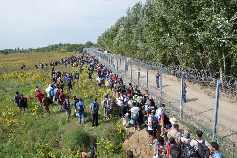 HORGOS, SERBIA - SEPTEMBER 15 : A large group of refugees from Middle East at the closed hungarian border with Serbia on September 15th, 2015. The migrants are waiting for the authorities to open the border crossing, so they can continue to the northern european countries. HORGOS, SERBIA - SEPTEMBER 15 : A large group of refugees from Middle East at the closed hungarian border with Serbia on September 15th, 2015. The migrants are waiting for the authorities to open the border crossing, so they can continue to the northern european countries.