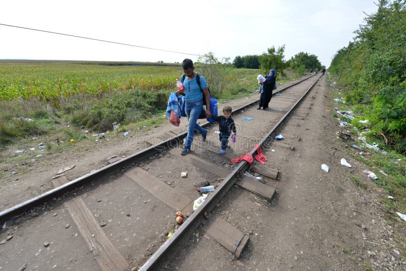 HORGOS, SERBIA - SEPTEMBER 15 : A large group of refugees from Middle East at the closed hungarian border with Serbia on September 15th, 2015. The migrants are waiting for the authorities to open the border crossing, so they can continue to the northern european countries. HORGOS, SERBIA - SEPTEMBER 15 : A large group of refugees from Middle East at the closed hungarian border with Serbia on September 15th, 2015. The migrants are waiting for the authorities to open the border crossing, so they can continue to the northern european countries.