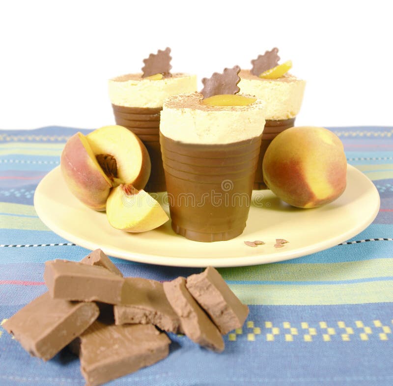 Peach cream desert served in chocolate cups. Peach cream desert served in chocolate cups