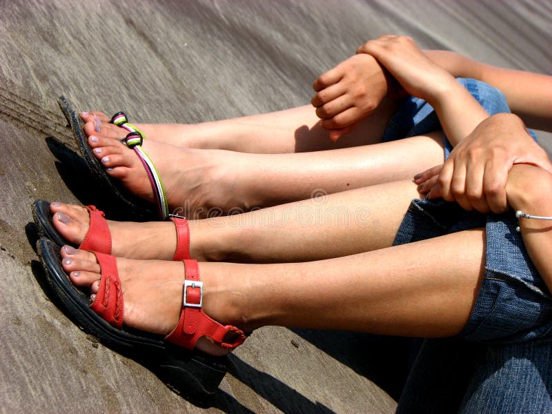 Beautiful legs of two women on a beach. Beautiful legs of two women on a beach