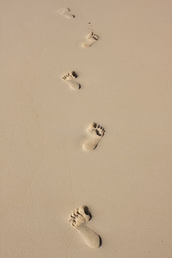 Bare feet footprints in the sand on beach. Bare feet footprints in the sand on beach