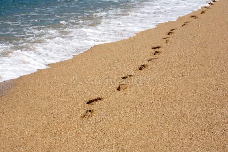 A photo of footprints on the sand. A photo of footprints on the sand