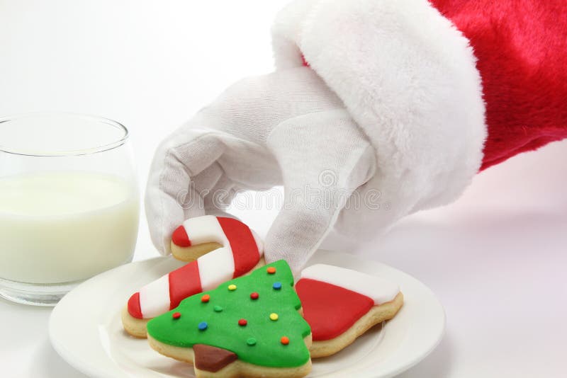 Santa Claus enjoying colorful Christmas cookies and a glass of milk. Santa Claus enjoying colorful Christmas cookies and a glass of milk.