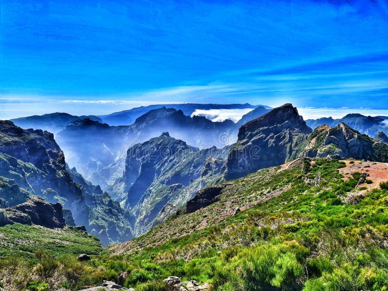 Pico do Areeiro, at 1,818 m (5,965 ft) high, is Madeira Island's third highest peak.[2] From the top, visitors can look down on the clouds on most days. The air is fresh and clear and the sun is very bright. On a clear day it is possible to see the neighboring island of Porto Santo, 48 km (30 mi) to the northeast.The footpath northwards towards Pico Ruivo is an important tourist attraction, with a daily average of 1000 tourists trekking on it.The peak has in recent times become popular with cyclists making the ascent from Funchal. Many cycling publications and online lists usually claim that the climb from sea level to the summit at Areeiro is one of the toughest in the world with 1810 meters of climbing over a very short distance of 22 kilometres. Pico do Areeiro, at 1,818 m (5,965 ft) high, is Madeira Island's third highest peak.[2] From the top, visitors can look down on the clouds on most days. The air is fresh and clear and the sun is very bright. On a clear day it is possible to see the neighboring island of Porto Santo, 48 km (30 mi) to the northeast.The footpath northwards towards Pico Ruivo is an important tourist attraction, with a daily average of 1000 tourists trekking on it.The peak has in recent times become popular with cyclists making the ascent from Funchal. Many cycling publications and online lists usually claim that the climb from sea level to the summit at Areeiro is one of the toughest in the world with 1810 meters of climbing over a very short distance of 22 kilometres.