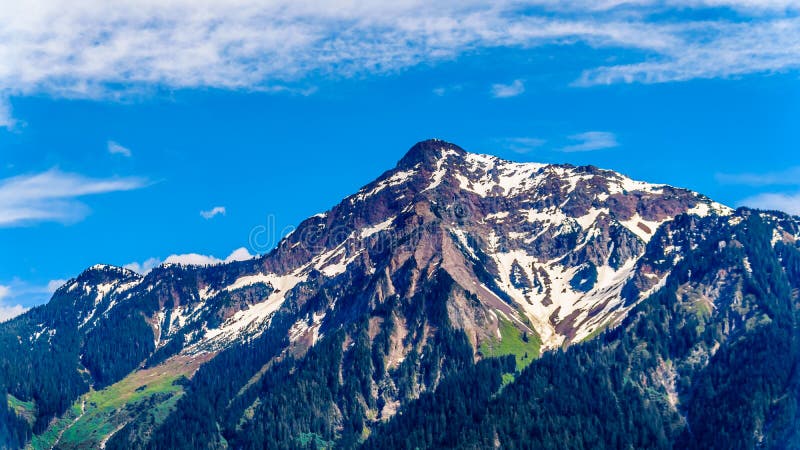 The pyramid shaped rugged top of Cheam Mountain, or Cheam Peak, that towers over the Fraser Valley of British Columbia, Canada. The pyramid shaped rugged top of Cheam Mountain, or Cheam Peak, that towers over the Fraser Valley of British Columbia, Canada