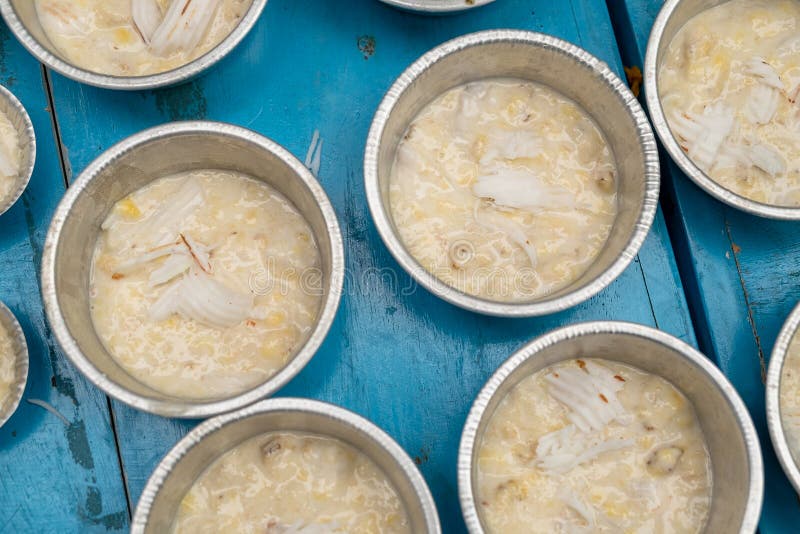 Пирог банана и мясо кокоса покрывая перед паром, традиционным десертом кухни Таиланда стоковое фото rf