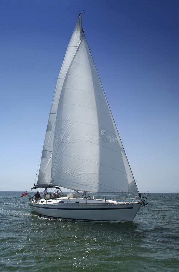 The large beautiful yacht with white sails on a background of the brightly light-blue clean sky and quiet sea. The large beautiful yacht with white sails on a background of the brightly light-blue clean sky and quiet sea.