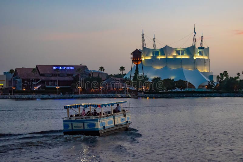 Orlando, Florida. June 15, 2019. Cirque du Soleil , House of Blues and taxi boat sailing in Disney Springs at Lake Buena Vista . Orlando, Florida. June 15, 2019. Cirque du Soleil , House of Blues and taxi boat sailing in Disney Springs at Lake Buena Vista .