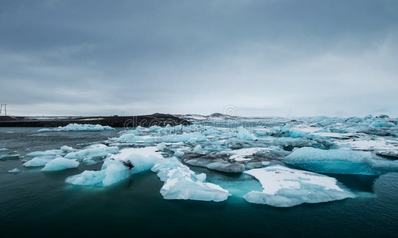 Плавя лед на воде в озере Jokulsarlon в южной Исландии в пасмурном дне глобальное потепление стоковые изображения rf Плавя лед на воде в озере Jokulsarlon в южной Исландии в пасмурном дне глобальное потепление стоковые изображения rf
