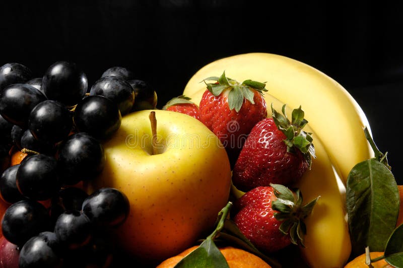 Fruits composition with orange, grape fruit, apple, strawberry, banana and kiwi on black background. Fruits composition with orange, grape fruit, apple, strawberry, banana and kiwi on black background