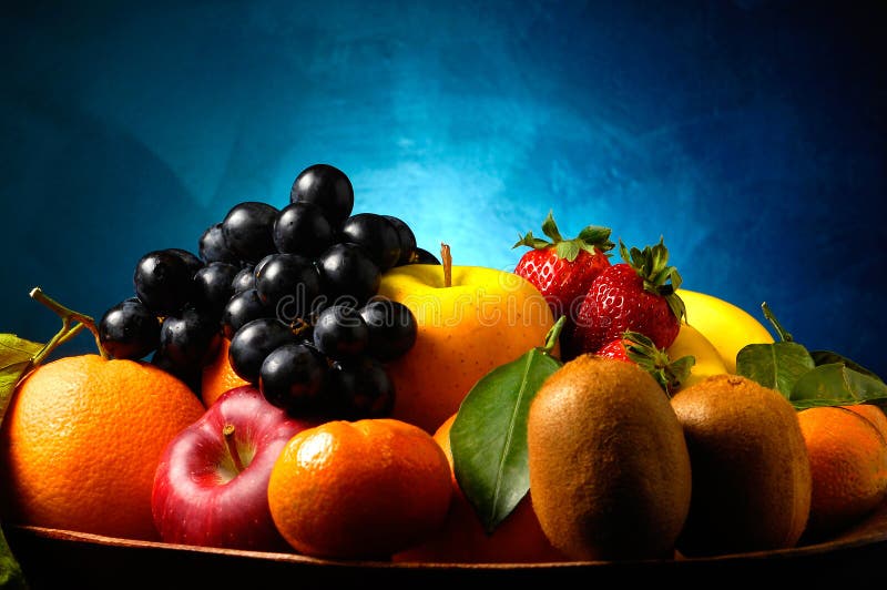 Fruits composition with orange, grape fruit, apple, strawberry, banana and kiwi on blue background. Fruits composition with orange, grape fruit, apple, strawberry, banana and kiwi on blue background