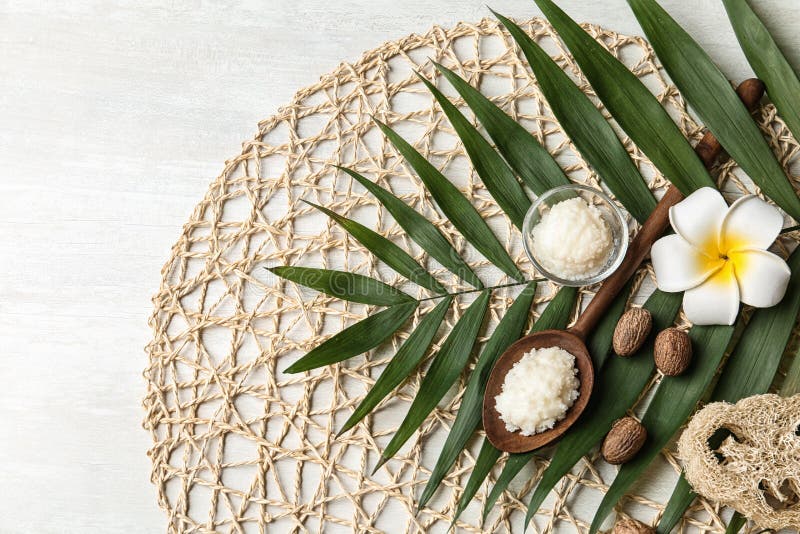 Flat lay composition with Shea butter, nuts and tropical leaf on light background. Space for text. Flat lay composition with Shea butter, nuts and tropical leaf on light background. Space for text