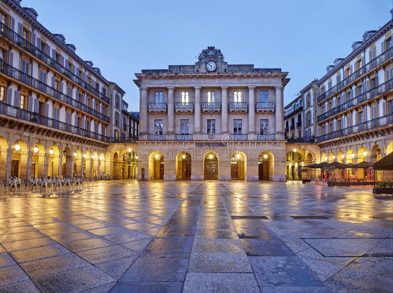 San Sebastian, Spain - November 14, 2019. The Constitution square at nightfall Plaza de la Constitucion. The central building in the background was, until 1947, the Town Hall of the city. San Sebastian, Basque Country, Guipuzcoa. Spain. San Sebastian, Spain - November 14, 2019. The Constitution square at nightfall Plaza de la Constitucion. The central building in the background was, until 1947, the Town Hall of the city. San Sebastian, Basque Country, Guipuzcoa. Spain