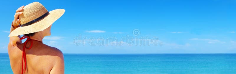 View of female in sailor-hat on a background of the tropical sea. Banner, lots of copyspace. View of female in sailor-hat on a background of the tropical sea. Banner, lots of copyspace.