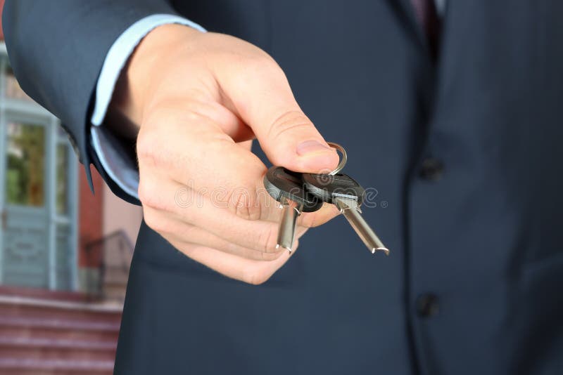 Подрезанное изображение агента по продаже недвижимости давая ключи дома стоковые фотографии rf