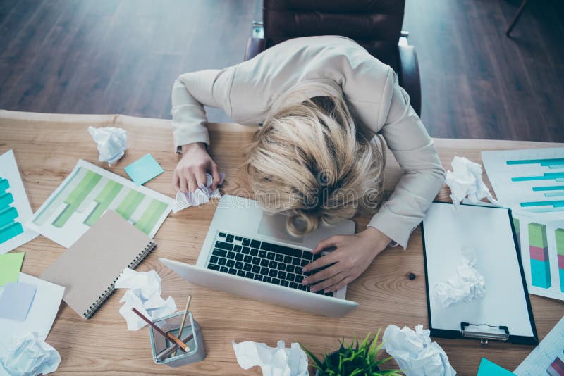 High angle above view photo of business lady head lying on desk listen online report crumple, papers awful corporate situation sit chair formalwear blazer workplace office. High angle above view photo of business lady head lying on desk listen online report crumple, papers awful corporate situation sit chair formalwear blazer workplace office