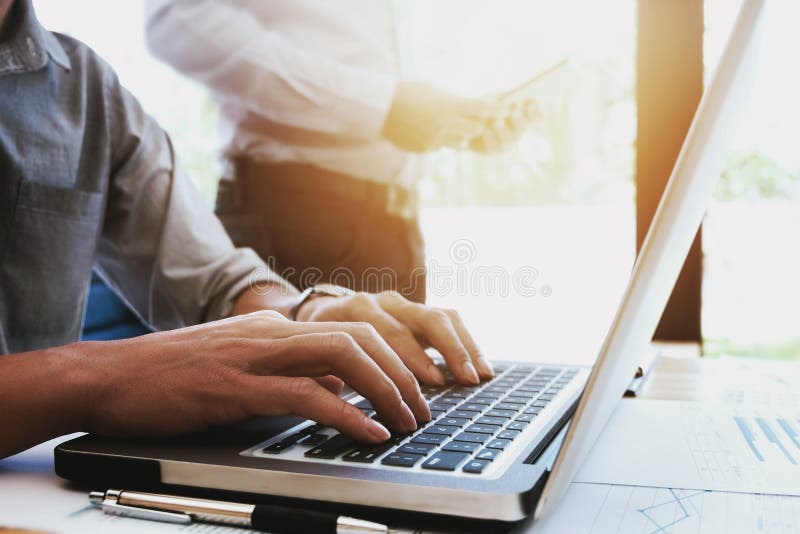 Подрезанное изображение красивых бизнесменов используя ноутбук на офисе стоковое изображение rf