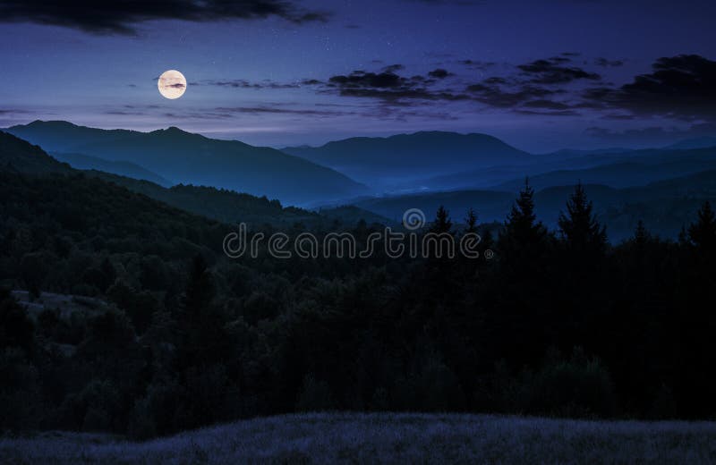 Full moon rise above forested mountain at night. gorgeous Carpathian nature scenery. Full moon rise above forested mountain at night. gorgeous Carpathian nature scenery