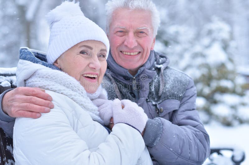 Elderly couple smiling and rejoicing in frosty winter. Elderly couple smiling and rejoicing in frosty winter