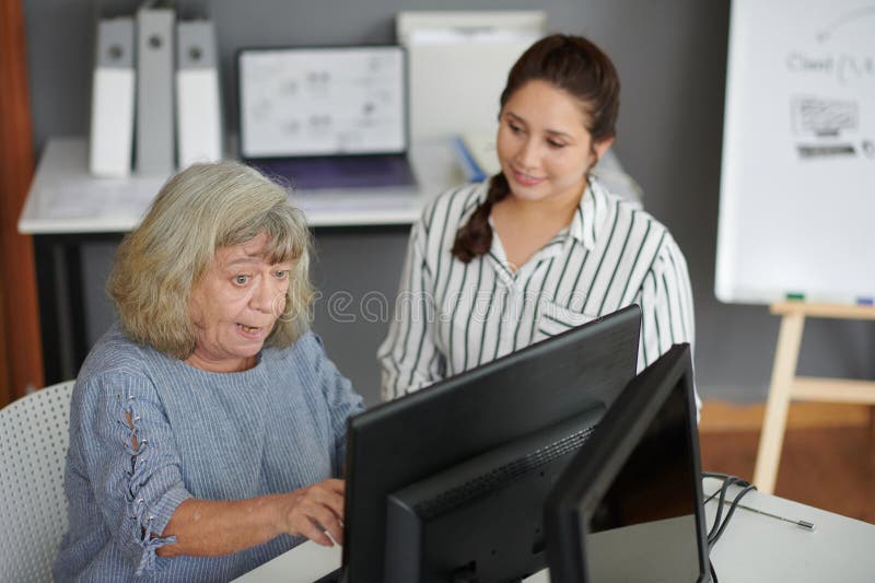 Aged woman learning how to send e-mails on computer. Aged woman learning how to send e-mails on computer