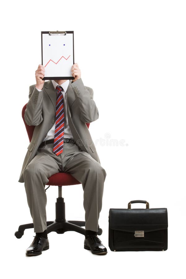 Portrait of stressed businessman sitting on armchair hiding his face with paper showing bad mood or confusion. Portrait of stressed businessman sitting on armchair hiding his face with paper showing bad mood or confusion