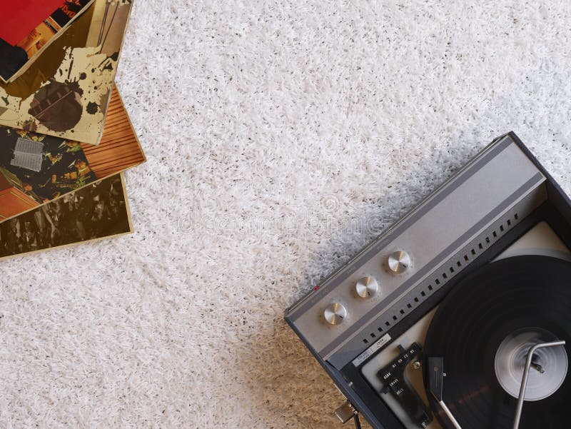 Record player and vinyl records on floor view from above. Record player and vinyl records on floor view from above