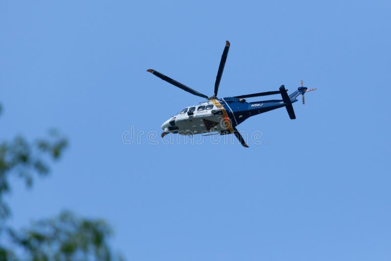 WOODBRIDGE, NEW JERSEY - June 1, 2020: A New Jersey State Police helicopter circles the area during late spring. WOODBRIDGE, NEW JERSEY - June 1, 2020: A New Jersey State Police helicopter circles the area during late spring