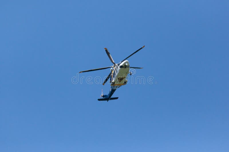 WOODBRIDGE, NEW JERSEY - June 1, 2020: A New Jersey State Police helicopter circles the area during late spring. WOODBRIDGE, NEW JERSEY - June 1, 2020: A New Jersey State Police helicopter circles the area during late spring