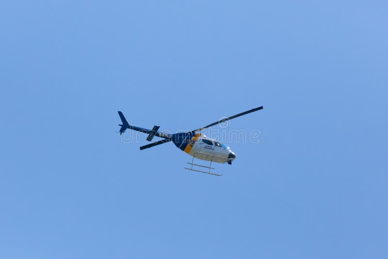 WOODBRIDGE, NEW JERSEY - June 1, 2020: A New Jersey State Police helicopter circles the area during late spring. WOODBRIDGE, NEW JERSEY - June 1, 2020: A New Jersey State Police helicopter circles the area during late spring