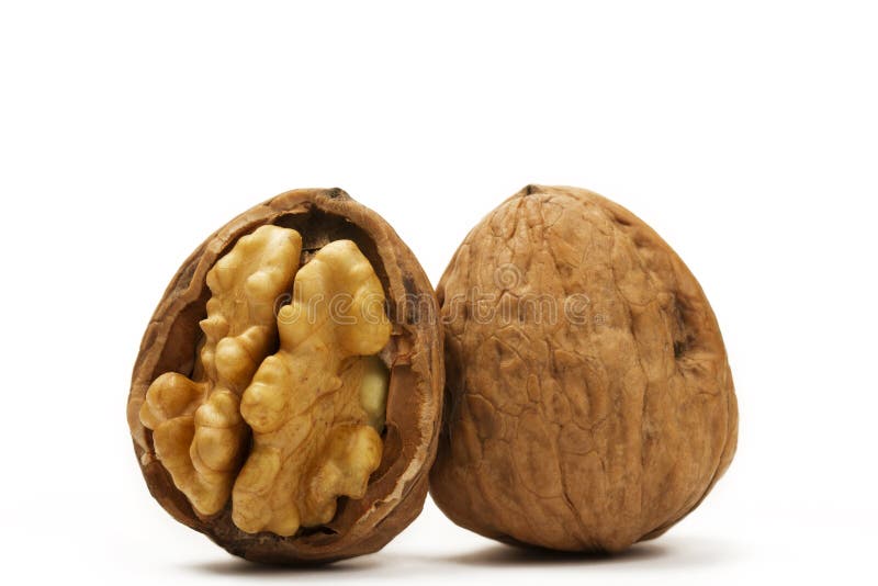 Walnut and a cracked walnut on white background. Walnut and a cracked walnut on white background