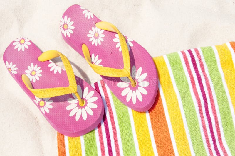 Colorful flip flops on beach towel. Colorful flip flops on beach towel