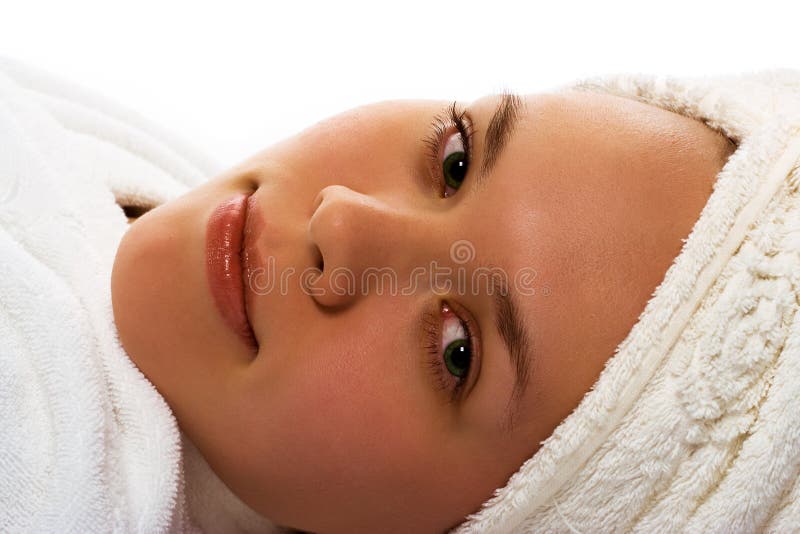 Beauty girl in towel relaxing after shower on white background. Beauty girl in towel relaxing after shower on white background