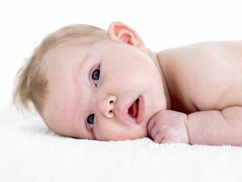 Newborn Baby Girl On Towel looking towards camera. Newborn Baby Girl On Towel looking towards camera