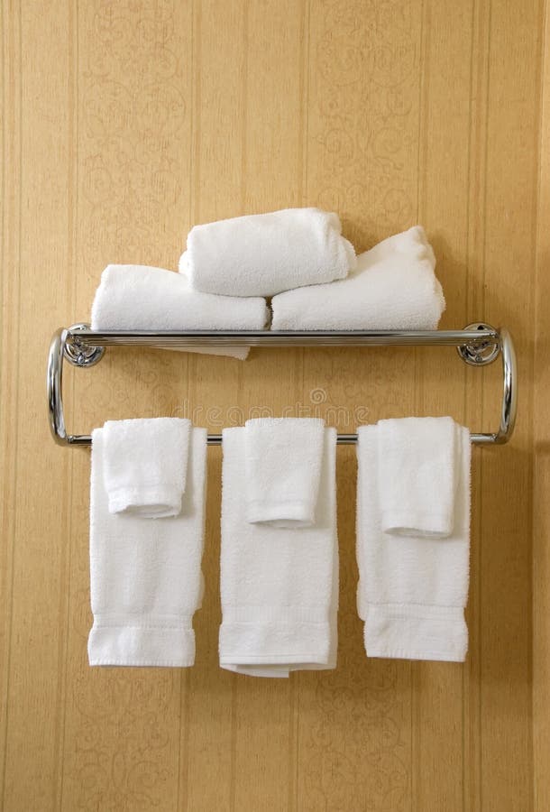 Silver towel rack with white terry cloth towels. Silver towel rack with white terry cloth towels