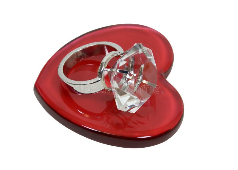 Diamond engagement ring with facets that sparkle brightly in the light symbolizing eternity of love on a red heart - path included. Diamond engagement ring with facets that sparkle brightly in the light symbolizing eternity of love on a red heart - path included