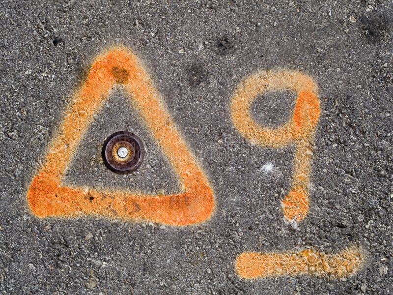 Orange paint marks on asphalt, used by construction or survey crew. Orange paint marks on asphalt, used by construction or survey crew.