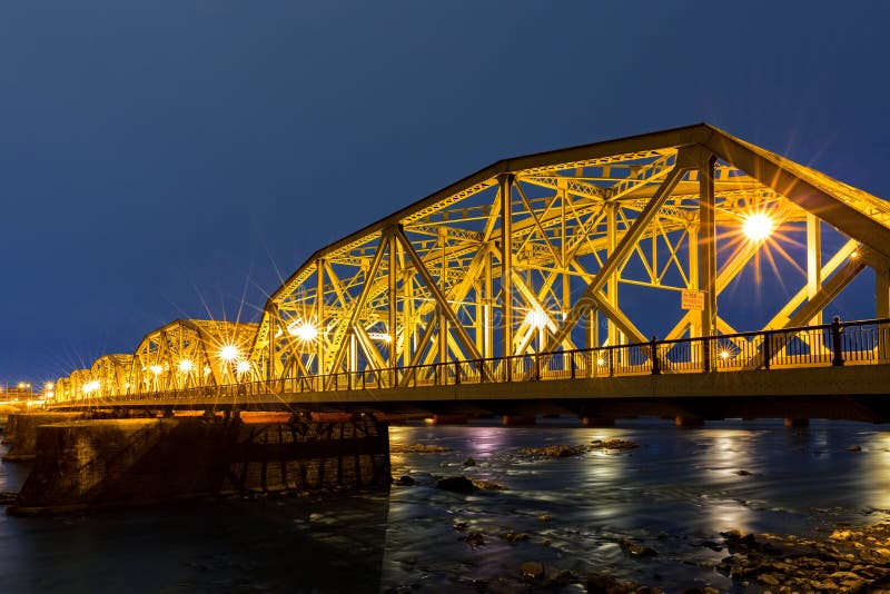 Lower Trenton Bridge at dawn. Lower Trenton Bridge also commonly called the Lower Free Bridge, Warren Street Bridge or Trenton Makes Bridge, spans Delaware River between Trenton NJ and Morrisville PA. Lower Trenton Bridge at dawn. Lower Trenton Bridge also commonly called the Lower Free Bridge, Warren Street Bridge or Trenton Makes Bridge, spans Delaware River between Trenton NJ and Morrisville PA