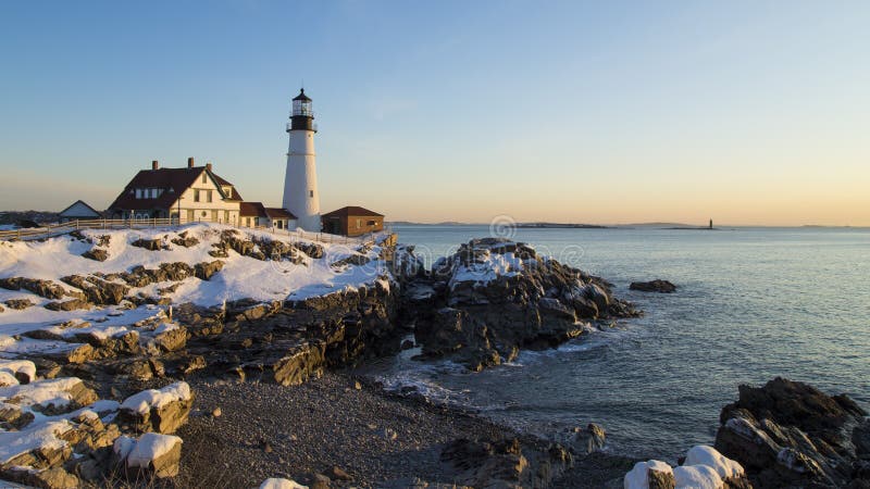 This is a view of a Winter sunrise on the Portland Head Lighthouse in Fort Williams Park near Portland, Maine. Ram Island Ledge Light can e seen in the distant background. This is a view of a Winter sunrise on the Portland Head Lighthouse in Fort Williams Park near Portland, Maine. Ram Island Ledge Light can e seen in the distant background.