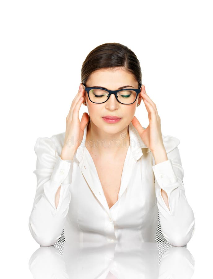 Portrait of a woman in glasses with strong headache. Business woman in white office shirt sits from the table - isolated on white background. Portrait of a woman in glasses with strong headache. Business woman in white office shirt sits from the table - isolated on white background