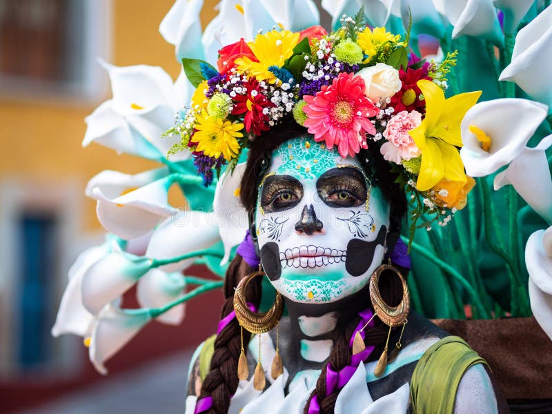 Portrait of a woman with beautiful Day of the Dead themed costumes and skull makeup on the streets of Guanajuato, Mexico. Portrait of a woman with beautiful Day of the Dead themed costumes and skull makeup on the streets of Guanajuato, Mexico.