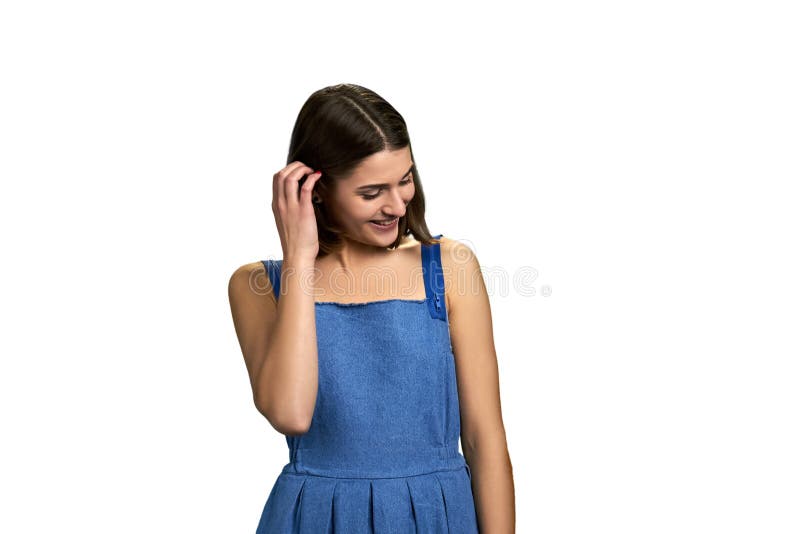 Portrait of shy girl on white background. Young smiling woman adjusting her hair. Pretty female student. Portrait of shy girl on white background. Young smiling woman adjusting her hair. Pretty female student.