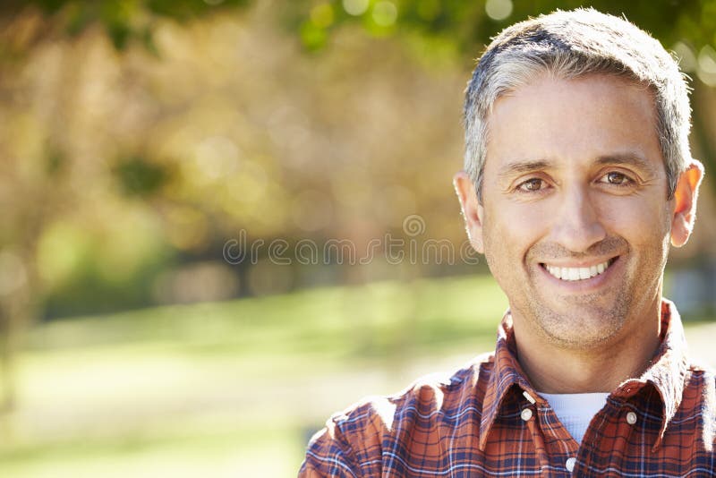 Portrait Of Hispanic Man In Countryside Smiling At Camera. Portrait Of Hispanic Man In Countryside Smiling At Camera