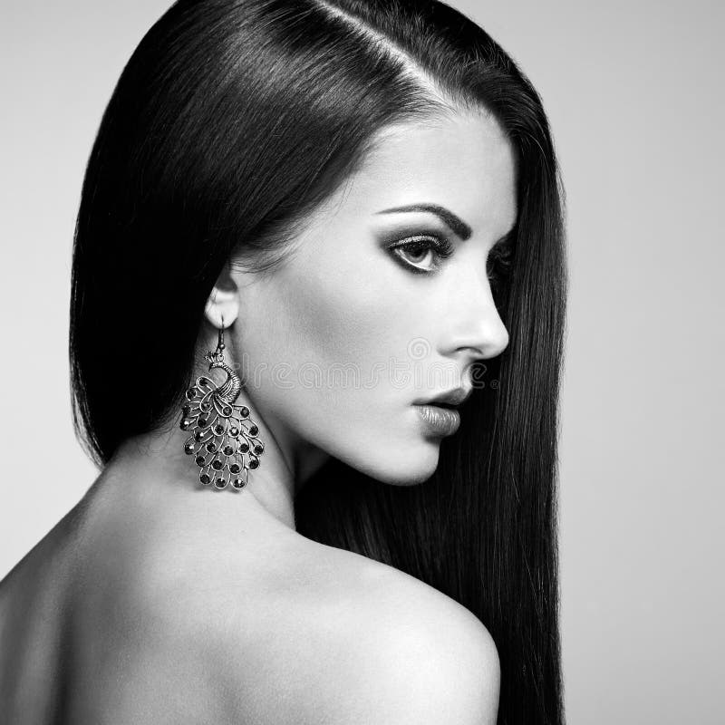 Portrait of beautiful brunette woman with earring. Perfect makeup. Fashion photo. Black and White. Portrait of beautiful brunette woman with earring. Perfect makeup. Fashion photo. Black and White