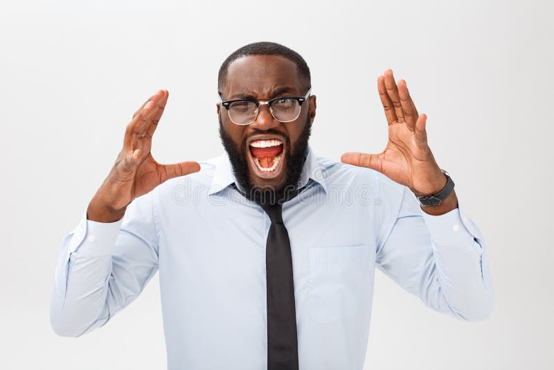 Portrait of desperate annoyed black male screaming in rage and anger tearing his hair out while feeling furious and mad with something. Negative human face expressions, emotions and feelings. Portrait of desperate annoyed black male screaming in rage and anger tearing his hair out while feeling furious and mad with something. Negative human face expressions, emotions and feelings