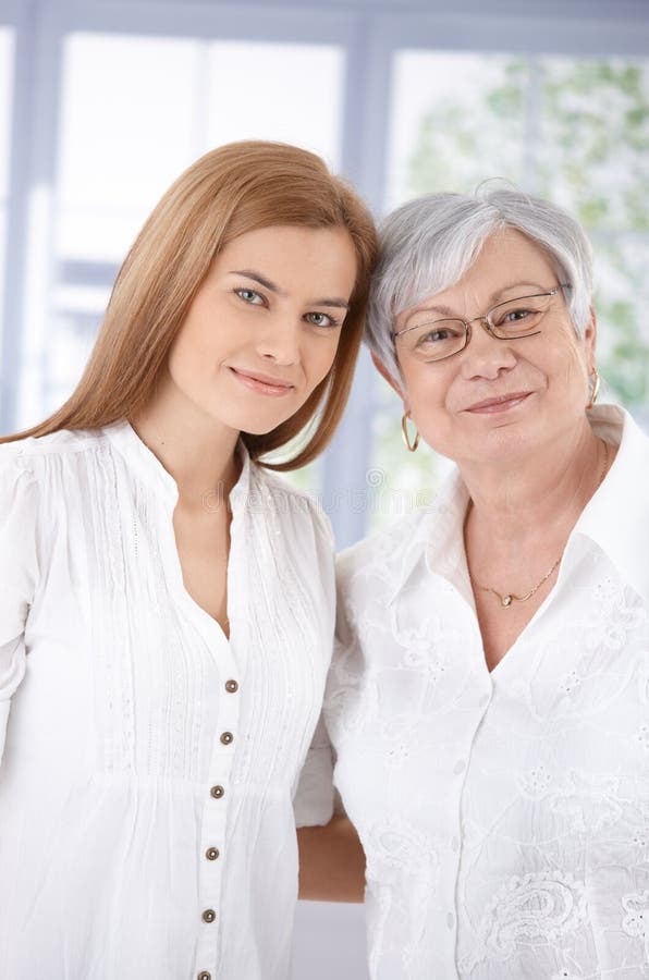 Portrait of senior mother and attractive adult daughter, hugging each other, smiling. Portrait of senior mother and attractive adult daughter, hugging each other, smiling.